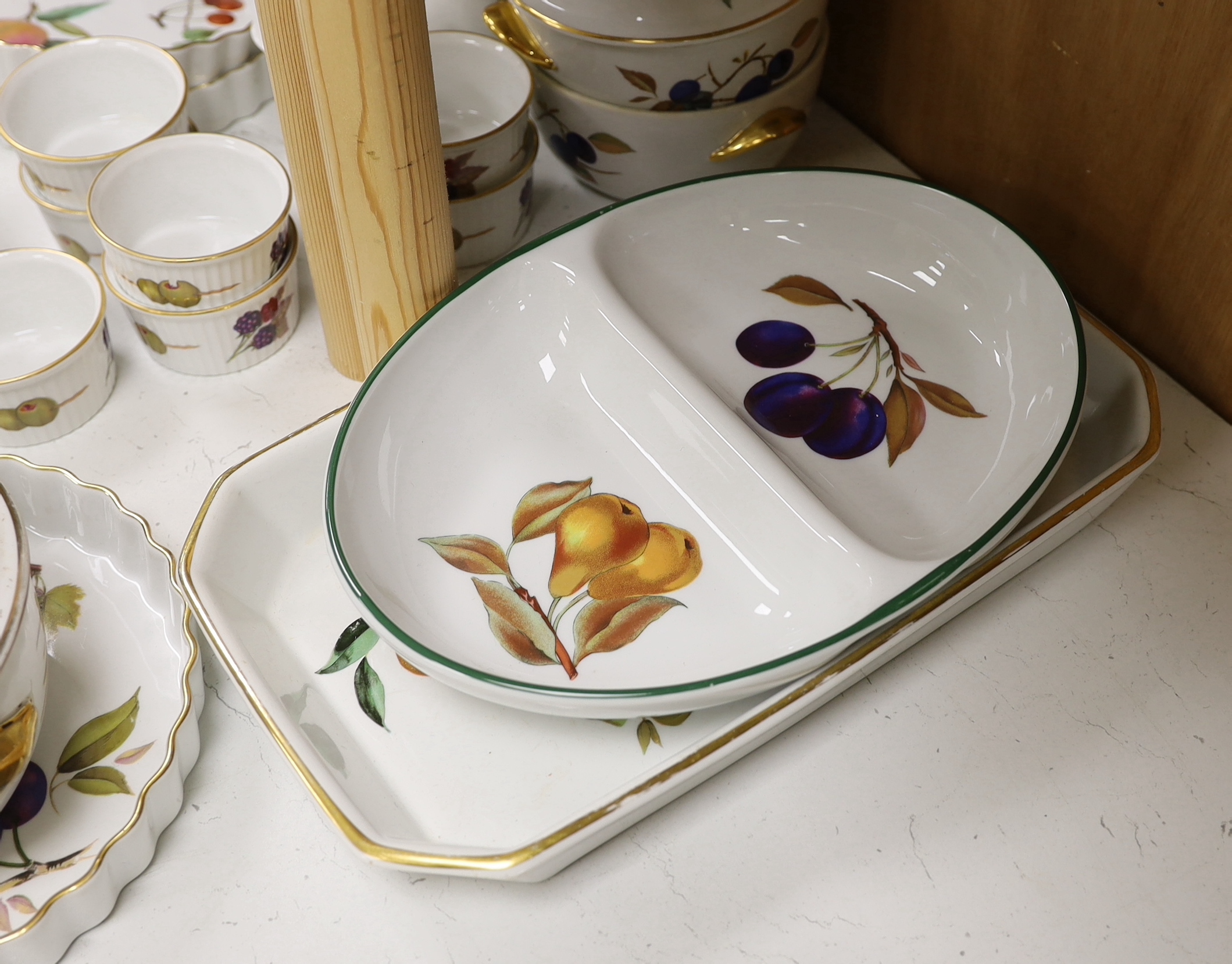 A Royal Worcester Evesham part dinner service, together with Portmeirion items including eight mugs, three lidded tureens, etc.